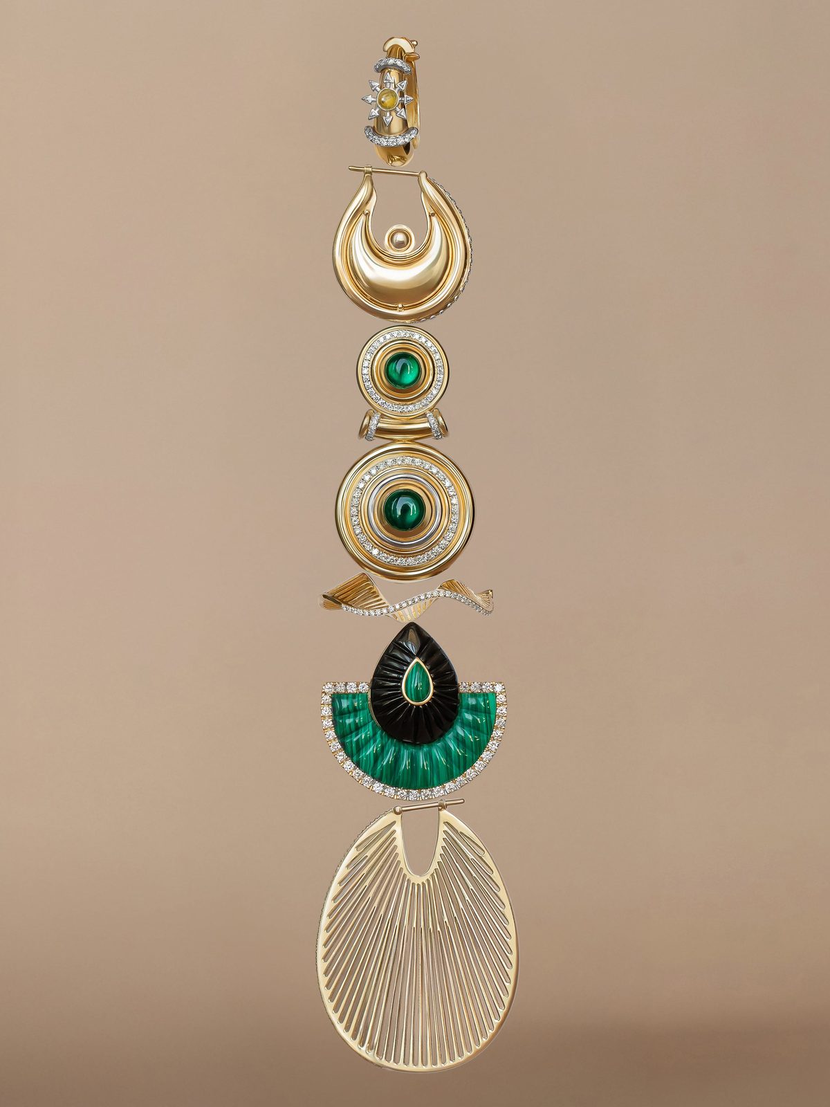 A vertical column of single earrings — a diamond huggie, a polished gold crescent hoop, malachite cabochon discs, a carved onyx and malachite fan and a fluted gold fan hoop.