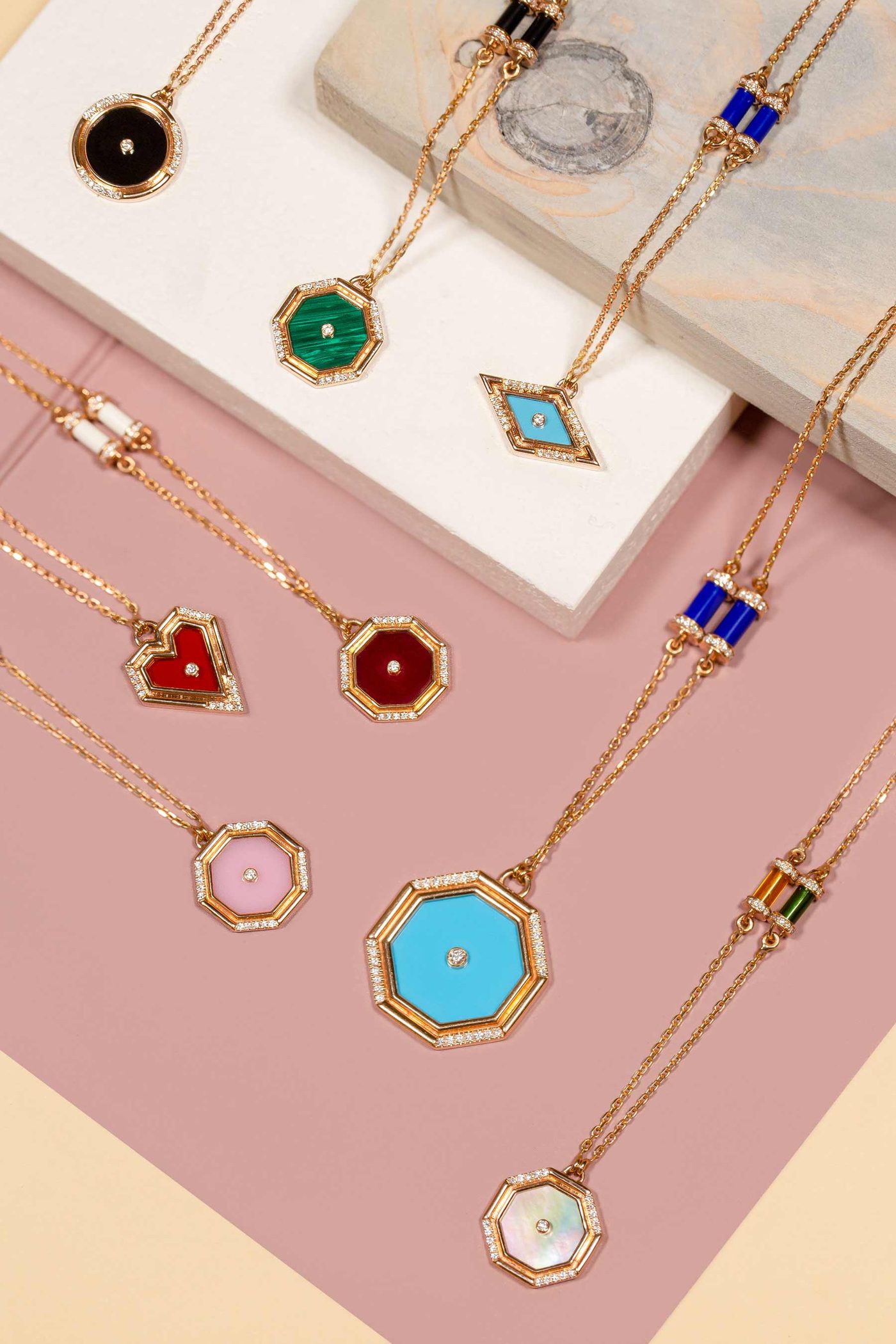 Amulets of Light pendants — octagonal, heart and diamond-shaped amulets in turquoise, malachite, coral, pink opal and mother-of-pearl on fine rose gold chains.