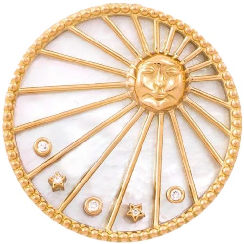 The Sun charm: a gold sun with a serene face at the centre of a mother-of-pearl disc, its rays set with diamond stars.